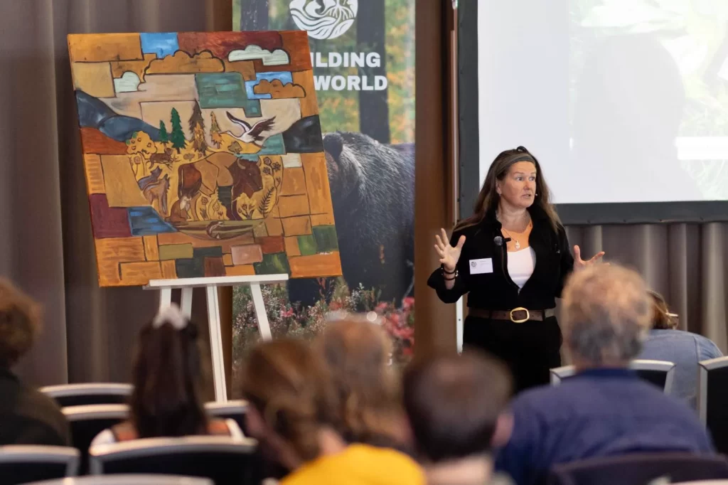 Nick Viney unveiling her live artwork at Rewilding Our World 2025, capturing the energy, ideas, and imagination of the conference through visual storytelling (Photo: Arjan Otte)